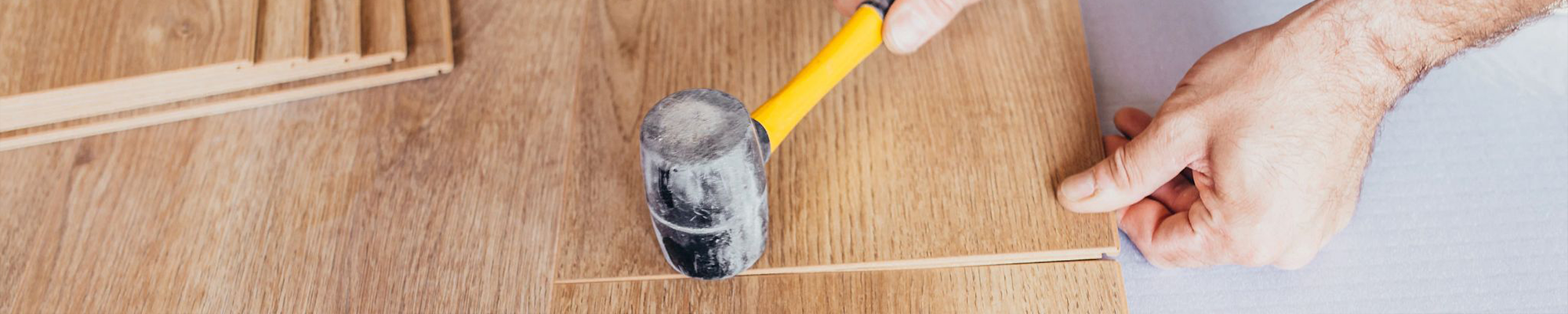 person installing flooring planks